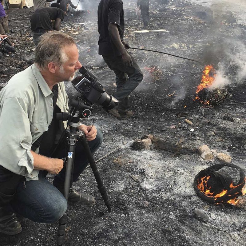 Burtynsky with Jim Panou in Agbogbloshie Recycling Yard, Accra, Ghana, 2017_Photograph by Nathan Otoo, courtesy of the Studio of Edward Burtynsky